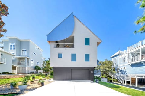 Design-forward guest house exterior with modern coastal architecture in a quiet 30A neighborhood