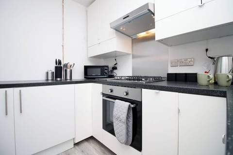 The fully equipped kitchen is ready for your culinary adventures, with everything you need to make delicious homemade meals. 