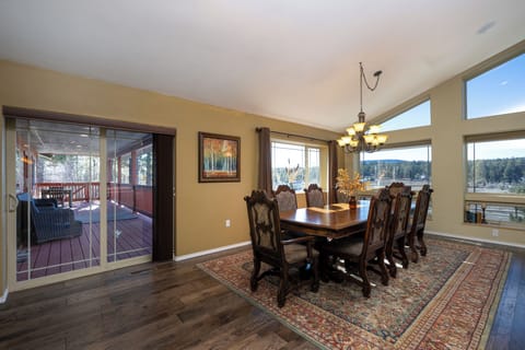 Gather around your elegant dining table while enjoying stunning mountain views through floor-to-ceiling windows and easy access to your private deck.