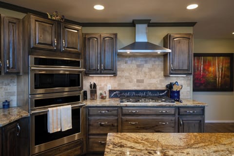 Your gourmet kitchen awaits with granite counters, stainless steel appliances, and rich wood cabinets for memorable meal preparation.