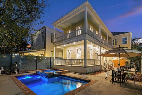Pool area at twilight facing the back of the home