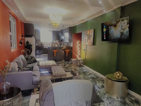 Family Apartment, Garden View | Living area | Flat-screen TV