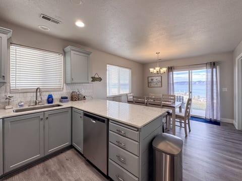 Bright kitchen and dining area with lake views—perfect for cooking, gathering, and enjoying scenic meals.