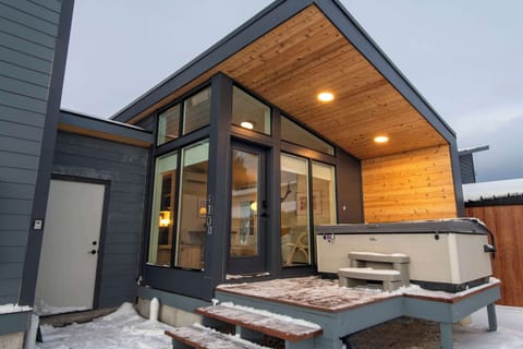The Nest entrance at Ski Hill Collective with a private hot tub and covered deck.