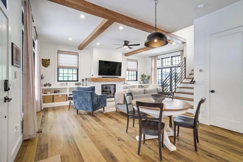 This inviting entry area opens directly into the open concept main floor and showcases the beautiful wood floors found throughout. The transition is seamless and highlights the spacious design of the home.
