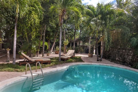 Pool view, surrounded by lush gardens.
