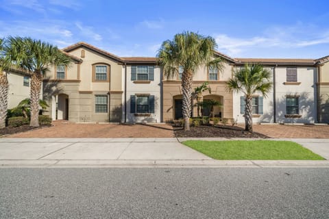 Welcome to your Windsor Westside retreat-Mediterranean-style townhome with palm-studded curb appeal and a spacious brick driveway.