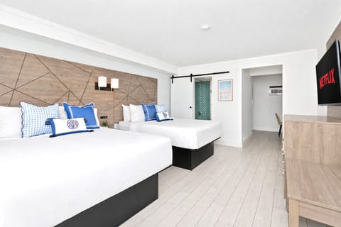 Bright, modern room with two cozy queen beds, a sleek flat-screen TV where guests can enjoy Netflix. Equipped with a mini fridge, microwave, and full curtains for privacy—designed for comfort and a truly restful stay.
