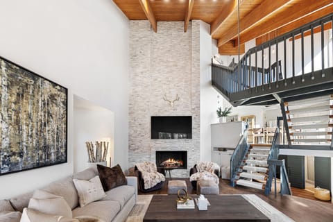 Comfortable lower-level (below main floor) living room featuring a cozy fireplace, smart TV, and ample seating. A great space for relaxing, movie nights, or unwinding after a day outdoors.