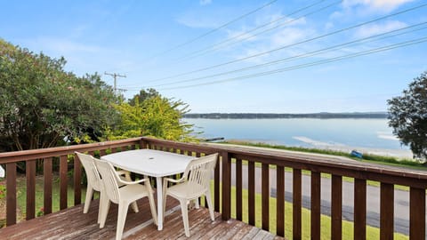 Deck with outdoor seating overlooking the water
