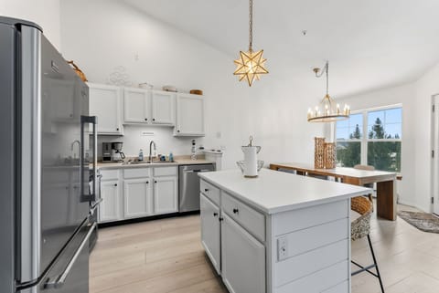 Your bright, fully-equipped kitchen awaits with modern appliances and a spacious island for morning coffee or meal prep.