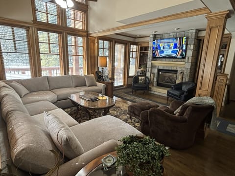 Cozy family room with sectional sofa sleeper, smart TV, gas fireplace and deck.