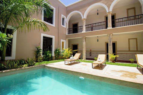 Unwind on cushioned loungers beside the sparkling tranquil pool.