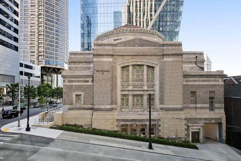 Admire the iconic historic façade nestled among downtown towers.