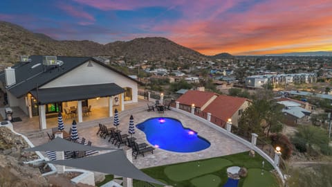 Sunset from your private mountainside—heated pool, travertine terrace, and the city glowing below. This is where Phoenix feels untouchable.