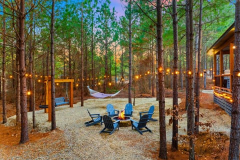 Swings an string lights surround the firepit area