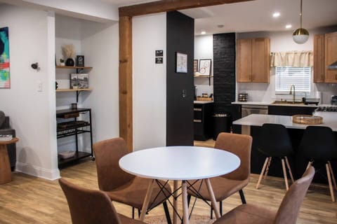 Bright dining area w/ a round table, stylish chairs, and natural light throughout