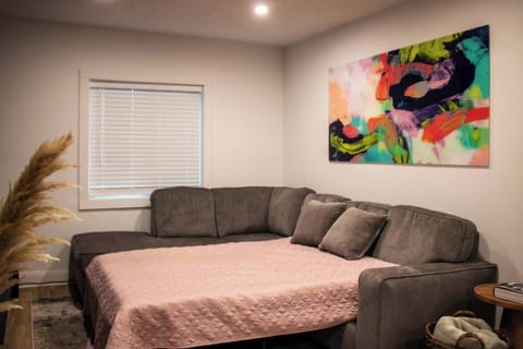 Bright living room w/ comfy seating, colorful art, and a cozy spot to unwind after a day out