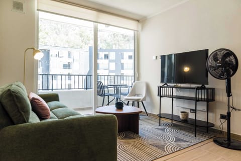 Relax in this bright living room with a balcony view, perfect for unwinding after a day of exploring.
