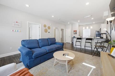 Bright open-plan lounge with breakfast bar and comfy sofa