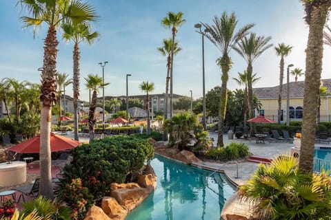 Resort-style pool surrounded by palm trees — the perfect escape on a sunny day.
