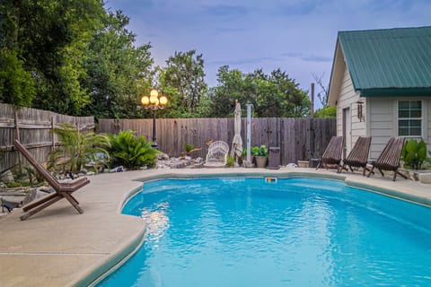 Welcome to your own private Backyard Oasis. Spa jets in pool bench seats & separate hot tub. Natural gas grill, oversized hammock for two, heated pool. Could it get any better?! Come, dive in ️