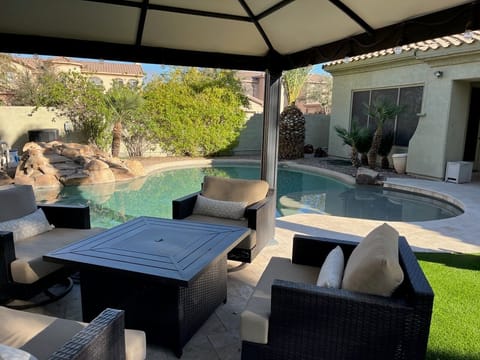 Lovely 5 BR, 3.5 BA home with heated pool, waterfall, covered patio and propane fire pit.