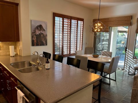 Kitchen has both table and counter seating plus a walk-in pantry for your supplies (not shown).