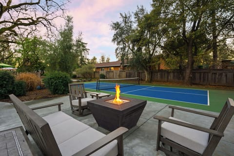 Evenings come alive around the fire pit, with a private pickleball court just steps away.