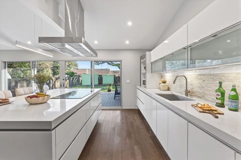 Bright, open kitchen designed for easy hosting, with seamless flow to indoor and outdoor gathering spaces.