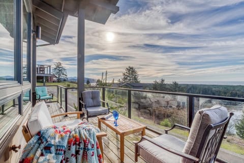 Unwind on your private deck with stunning views across forested landscapes and distant mountains, where comfortable seating awaits your morning coffee or evening relaxation.