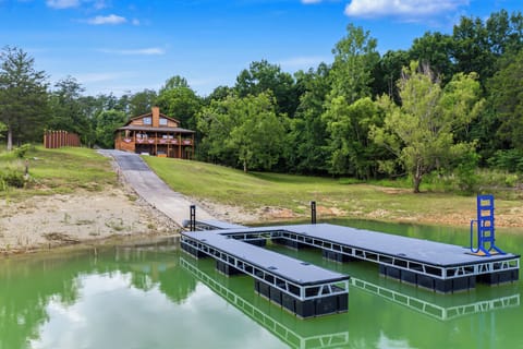 A tranquil lakefront retreat with private dock and spacious grounds, surrounded by lush forest and rolling hills—your perfect escape to nature.