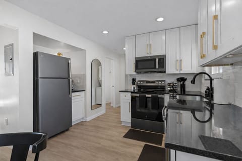 Sleek, fully equipped kitchen with modern appliances, ample counter space, and clean finishes—perfect for cooking, meal prep, or easy everyday dining.