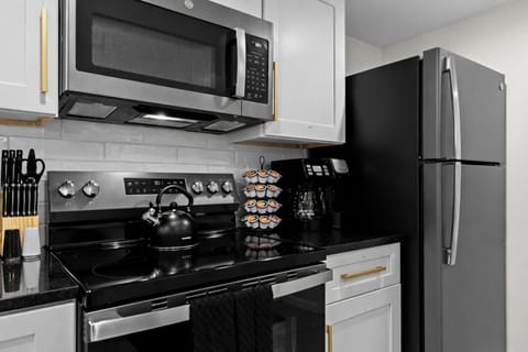 Fully stocked modern kitchen with stainless appliances, coffee station, and sleek finishes—everything you need for easy cooking and relaxed mornings.