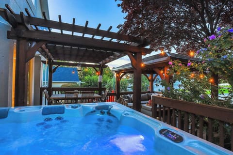 Hot tub and Gazebo in serene setting right off the kitchen and family room with incredible mountain view. Granite table seating 8. Perfect to play cards and share stories or lounge under the gazebo on the cushioned couches and light the fire pit.