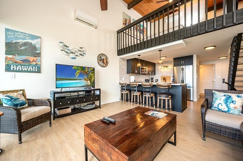 Kick back under lofted ceilings surrounded by tropical art, woven accents, and a sleek, beach-ready kitchenette NAP-C43