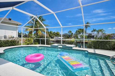 Overhead view of the pool with a pink float and colorful pool toys