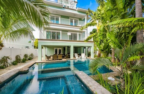 This stunning resort-style pool welcomes you with cascading water features, lush palms, and a peaceful island vibe. Whether you’re cooling off in the sun or enjoying a quiet evening soak, this space sets the tone for pure vacation bliss.