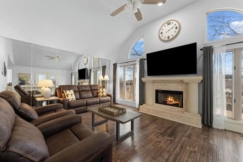 Vaulted living room with wood burning fireplace & recliners