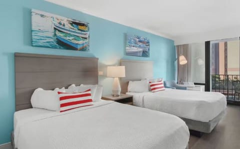 Relax in coastal comfort with soft lighting and roomy beds.