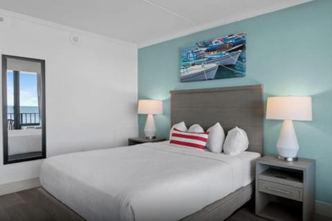 Unwind in crisp linens with a hint of ocean beyond.