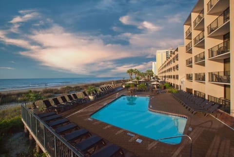 Soak in sunset glow while lounging by the beachfront pool.