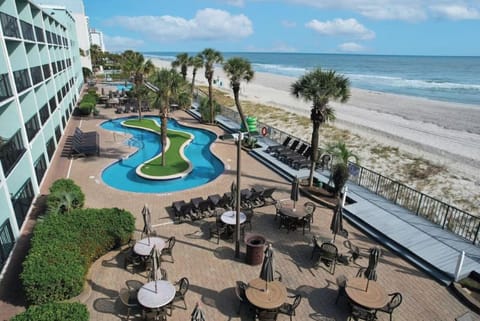 Feel the beachfront vibe with pools, loungers, and sand nearby.