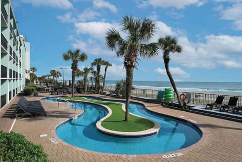 Unwind beside the curving pool with ocean breezes nearby.