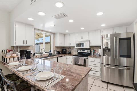 Clean and functional kitchen featuring ample storage & full size appliances