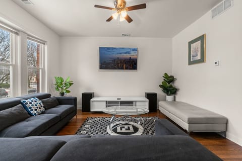 Spacious living room with hardwood floors, Smart TV, and comfy seating.