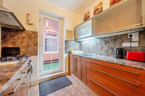 Cook and prep meals in the kitchen with long counters and a door leading outside