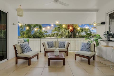 Linger on the balcony over outdoor dining, with fresh breezes and palm views setting a relaxed coastal mood.