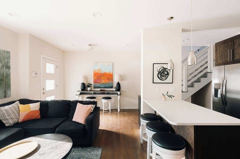 Living area, entry, and open kitchen with island