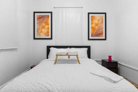 A comfortable queen bedroom with a simple, modern feel.